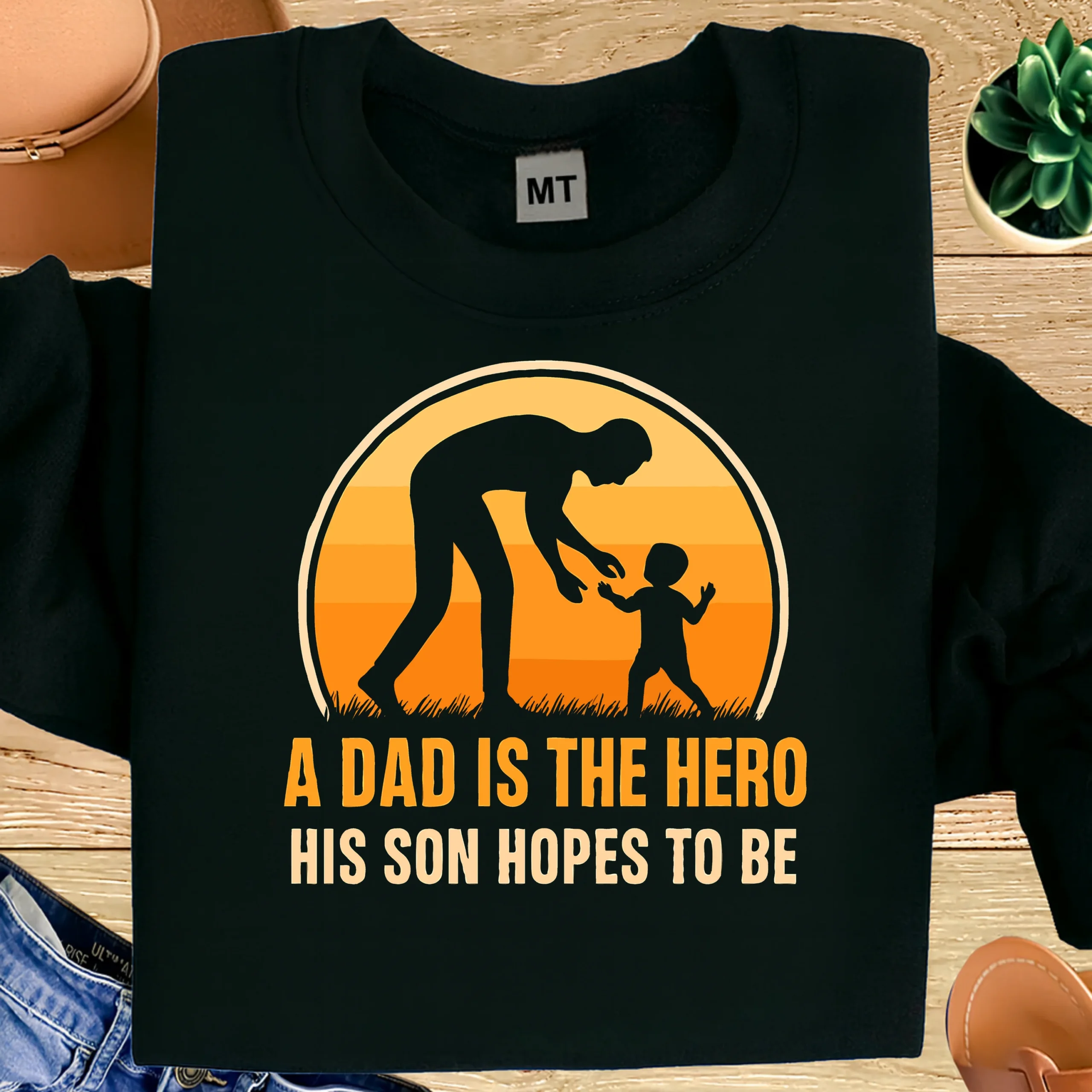 “A Dad Is The Hero His Son Hopes To Be” printed cotton T-shirt. Soft, breathable fabric with durable print. Perfect Father’s Day gift in UAE.