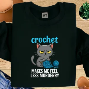 Funny crochet cat T-shirt with quote “Crochet makes me feel less murdery”. Perfect humor tee for crochet lovers and cat fans.