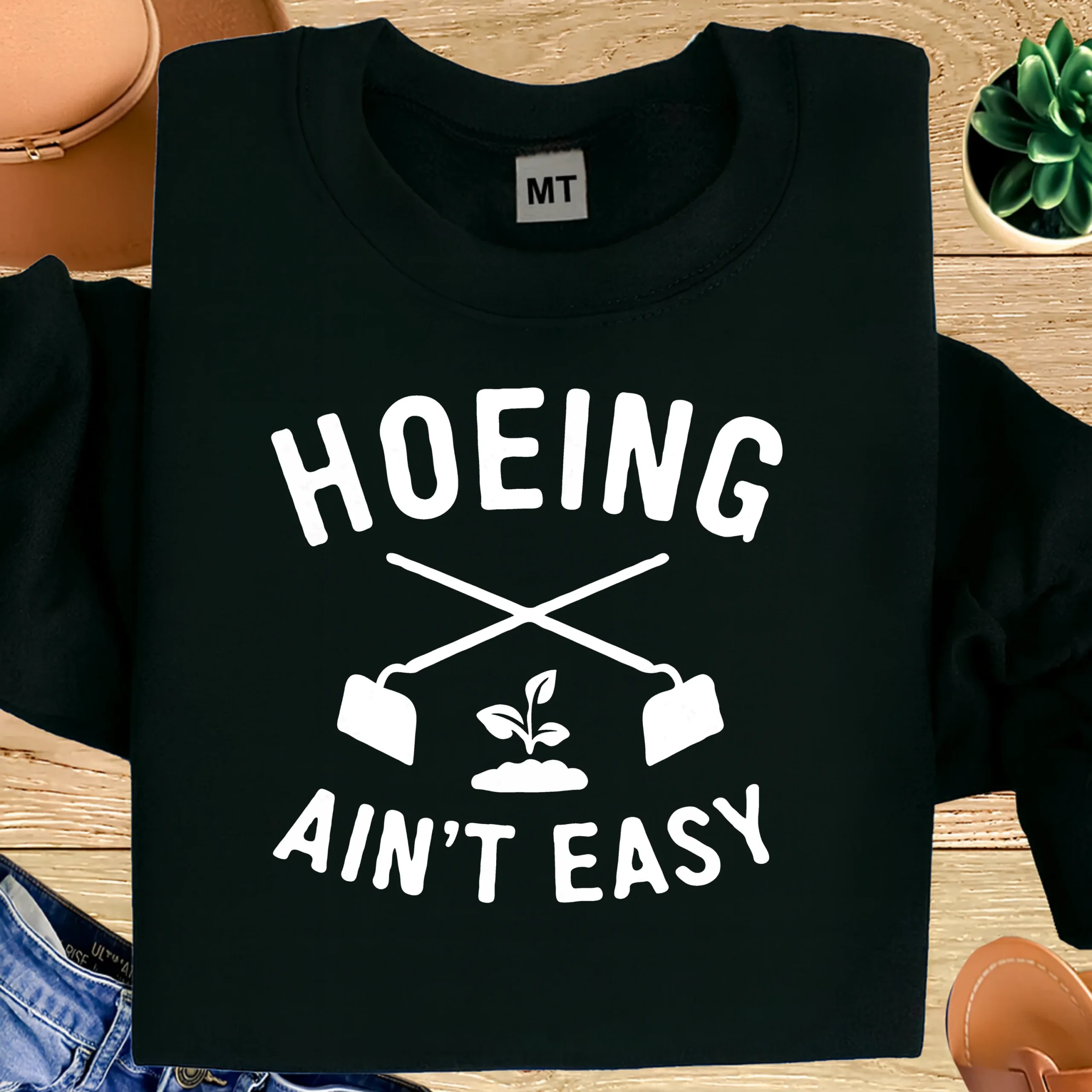 Hoeing Ain’t Easy gardening T-shirt made from premium cotton. A funny gardener humor shirt perfect for plant lovers and outdoor gardening fans.
