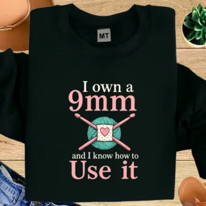 Funny crochet T-shirt with “I Own a 9mm and I Know How to Use It” quote. Perfect for crocheters, knitters, and yarn lovers with a sense of humor.