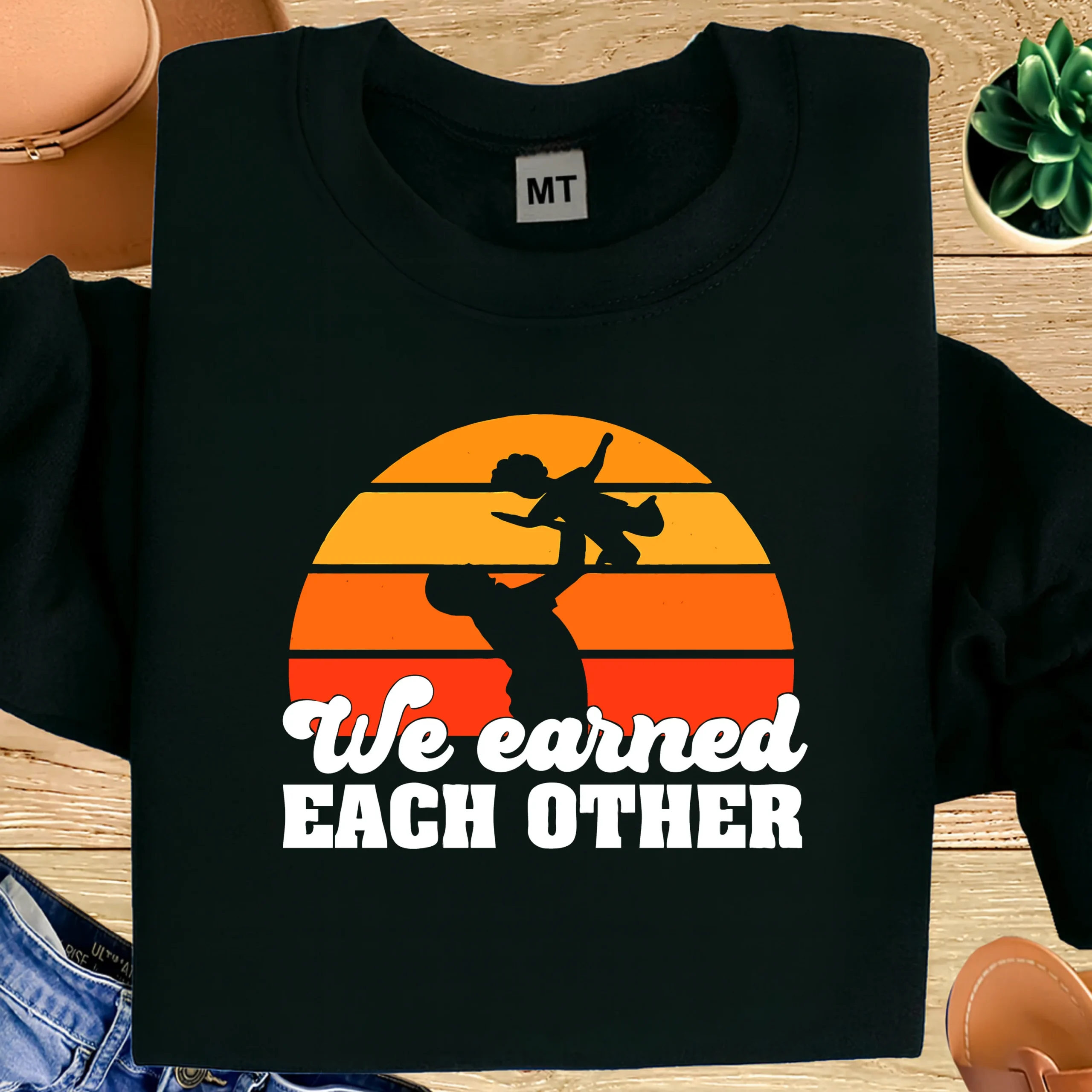 “We Earned Each Other” printed cotton T-shirt celebrating father & child bond. Soft, breathable fabric with durable print. Perfect dad gift in UAE.