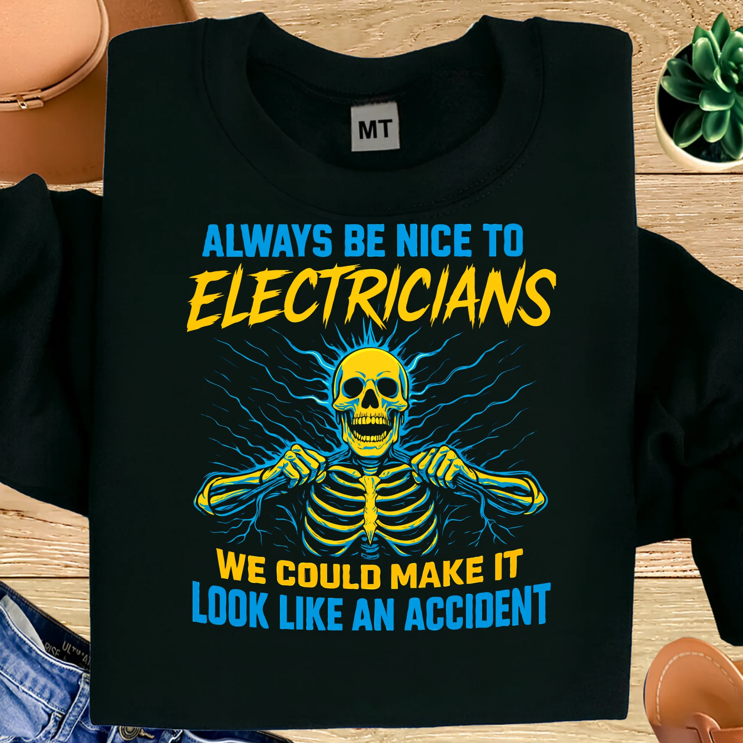 Funny electrician T-shirt with “Always Be Nice to Electricians” design. Bold trade humor tee for electricians, linemen, and blue-collar workers.
