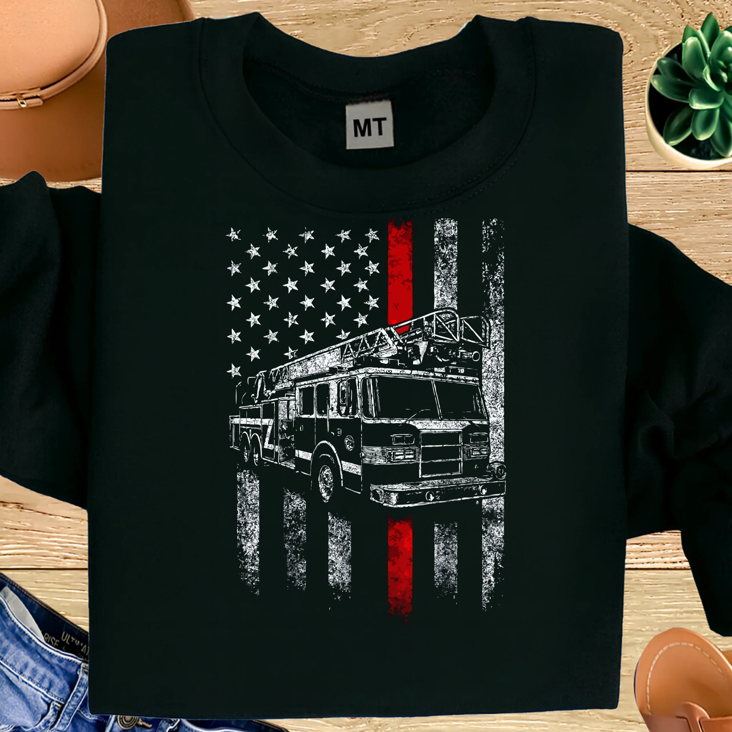 Bold firefighter American flag T-shirt featuring ladder truck design. Premium cotton tee for firefighters, fire crews, and patriotic first responders.