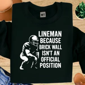 Funny lineman T-shirt with “Brick Wall Isn’t an Official Position” quote. Premium football humor tee for linemen, players, and fans.